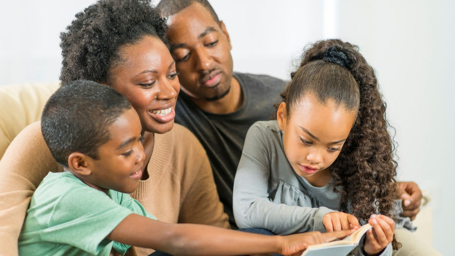 A family together reading a book